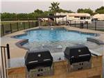 View larger image of The swimming pool and BBQ area at KATY LAKE RV RESORT image #9