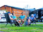 Four people sitting in chairs near RVS - thumbnail