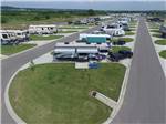 View larger image of Aerial view of RVs parked in pull-thru sites at BY THE LAKE RV PARK RESORT image #9