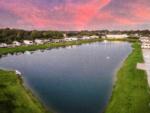 RVs by the pond at sunset at Fallbrook RV Resort - thumbnail