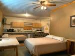 Beds and kitchen area in a rental cabin at D & S CAMPGROUND & LODGE - thumbnail