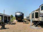 RVs in gravel sites near a small pavilion at D & S CAMPGROUND & LODGE - thumbnail