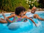 Male and child in the lazy river at LAKE COMPOUNCE CAMPGROUND - thumbnail