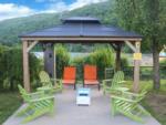 Cabana with chairs by the lake at LAKE COMPOUNCE CAMPGROUND - thumbnail