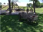 View larger image of A wagon in a grassy area at FLAT CREEK FARMS RV RESORT image #4