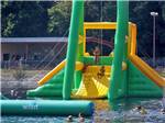 View larger image of Kids going down an inflatable water slide at CRYSTAL LAKE RV PARK image #6