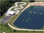 View larger image of An aerial view of the lake and go-cart track at CRYSTAL LAKE RV PARK image #12