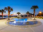 The pool and palm trees at Brazoria Lakes RV Resort - thumbnail