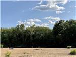View larger image of A large sandy field with a lone picnic bench at BEACH CAMPING AREA image #8