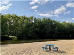 View larger image of A circular picnic table next to the water at BEACH CAMPING AREA image #10