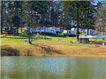 View larger image of Small lake with RVs in distance at COBBLE HILL CAMPGROUND image #4