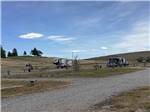 A gravel road and RV sites at CHOTEAU MOUNTAIN VIEW RV CAMPGROUND - thumbnail