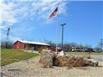 View larger image of Landscaping and flag at BAR J HITCHIN POST RV image #1