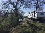 An RV site by the water at RIVERSIDE PARK RV - thumbnail