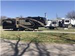 Two fifth wheels parked in RV sites at RIVERSIDE PARK RV - thumbnail