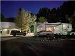 A fifth wheel trailer at night at WORLAND RV PARK AND CAMPGROUND - thumbnail