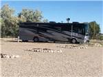A motorhome in a gravel RV site at WORLAND RV PARK AND CAMPGROUND - thumbnail