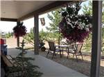 Potted flowers hanging from the porch at RENDEZ VOUS RV PARK & STORAGE - thumbnail