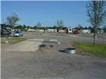 View larger image of One of the empty RV sites at TYLER OAKS RV RESORT image #5