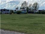 Sprawling lawn abuts RV campground at SLEEPING WOLF CAMPGROUND & RV PARK - thumbnail