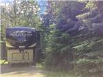 A fifth wheel trailer in a RV site at THE HEMLOCKS RV AND LODGING - thumbnail