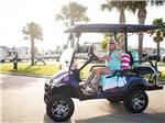 A lady driving a golf cart at STELLA MARE RV RESORT - thumbnail