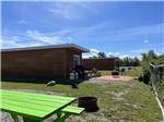 View larger image of Green picnic table and cabins at PIRATES HAVEN RV PARK  CHALETS image #5