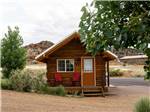 Exterior of cabin with chairs on front porch Escalante Grand Resort - thumbnail