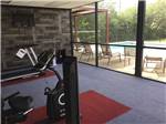 View larger image of Inside of the exercise room looking out at the pool at TEJAS VALLEY RV PARK image #3