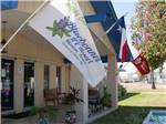 View larger image of Flags on the front of the main building at BLUEBONNET RV RESORT image #1