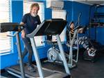 View larger image of A man and lady using the exercise equipment at BLUEBONNET RV RESORT image #7