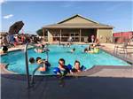 View larger image of Kids having fun in the blue pool at WHISTLE STOP RV RESORT image #12