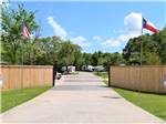 Entrance to park flanked with flags at Stonebridge RV Park & Resort - thumbnail