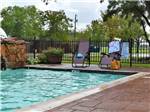 Lounge chairs around the pool at Stonebridge RV Park & Resort - thumbnail