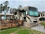 A motorhome with a fenced patio at DEEP CREEK RV RESORT & CAMPGROUND - thumbnail