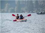 A couple paddling in a boat at SHELTER COVE RESORT AND MARINA - thumbnail