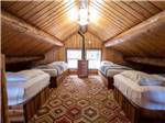 Four single beds in a rental cabin at SHELTER COVE RESORT AND MARINA - thumbnail