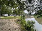 View larger image of The campsites by the river at HIDDEN SPRINGS RV RESORT image #2