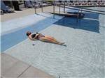 Woman sunning herself in the shallow pool at NMB RV RESORT AND DRY DOCK MARINA - thumbnail