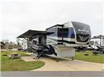 Fifth-wheel RV with slide-outs on an overcast day at NMB RV RESORT AND DRY DOCK MARINA - thumbnail