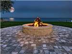 Fire pit with the moon over the lake at NORTHPOINTE SHORES RV RESORT - thumbnail