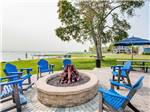 Blue chairs around a fire pit at NORTHPOINTE SHORES RV RESORT - thumbnail