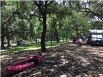 View larger image of A kayak and campers under the trees at RIVERBEND ON THE FRIO image #2
