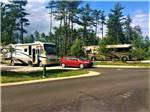 Motorhomes in paved sites with dinghy car at MANISTIQUE LAKESHORE CAMPGROUND - thumbnail