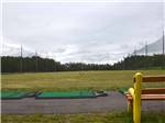 View larger image of The driving range with a bench at BEAR PAW PAR 3 GOLF COURSE  RV PARK image #3