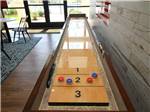 An indoor shuffleboard court at JETSTREAM RV RESORT - TROPICAL TRAILS - thumbnail