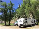 View larger image of A travel trailer backed into a campsite at RUSHMORE VIEW RV PARK image #7