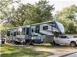 A fifth-wheel RV and truck at site - thumbnail