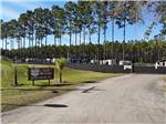 View larger image of Welcome sign with trees and RVs in background at CLAY FAIR RV PARK image #3