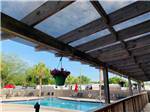 View of the swimming pool from covered deck at WILDWOOD RV VILLAGE - thumbnail